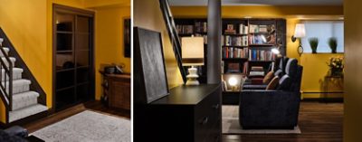 Basement interior featuring Goldenrod yellow walls, carpeted stairs, a cozy sitting area with built-in bookshelves, and cushioned chairs.