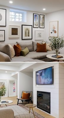 A basement living room with a gray sectional sofa, framed art, and a wall-mounted TV above a fireplace. 
