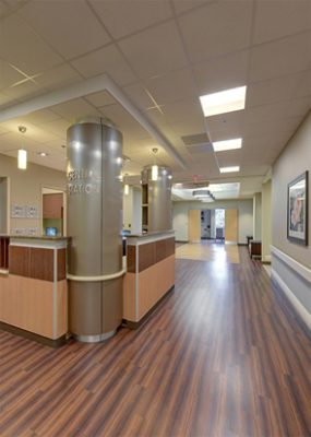 Healthcare station with columns and vinyl wood flooring.