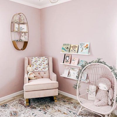 A nursery with pink walls and furniture