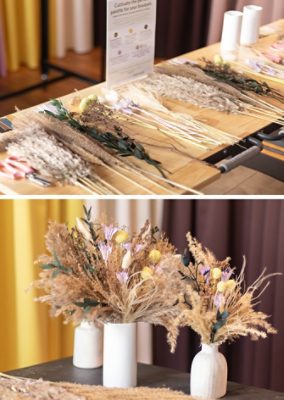 Shown on left, an assortment of dried florals arranged neatly on a wood table in preparation for assembly of a bouquet. Shown on right, three white vases sitting on a dark surface and each containing assembled Forever Floral bouquets.