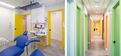 Interior of dental exam room and corridor with white walls and cheerfully bright multicolored doors and trim.