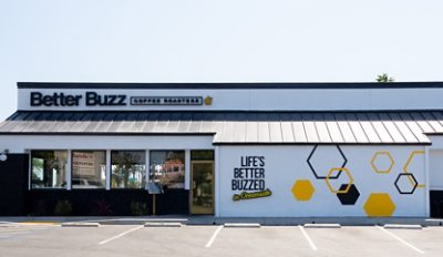 Exterior of the Better Buzz Coffee Roasters Oceanside location with signage and hexagonal designs. 