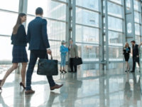 People walking with briefcases in a breezeway 