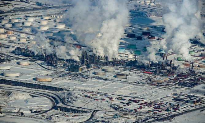 a snow covered oil refinery in winter