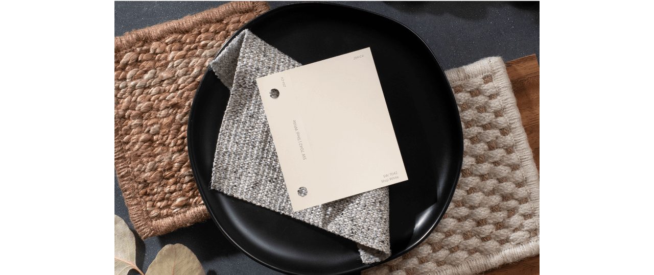 A light neutral color chip on top of a folded cloth napkin and black plate.