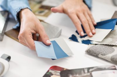 A person looking at color chips and other design elements.