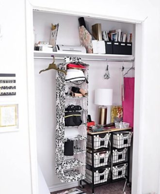 An organized white closet with shelves and hanging closet organizer.