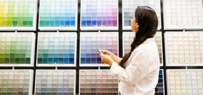 Person looking at color chips in the color wall.