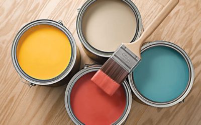 Four cans of yellow, beige, blue and red paint