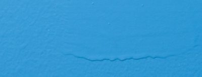 A blue painted surface with some sagging.