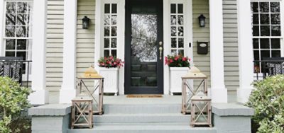 The front of a house with a gray brick porch