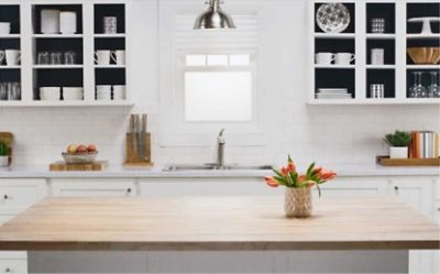 A kitchen with cabinets painted white on the outside and black on the inside.