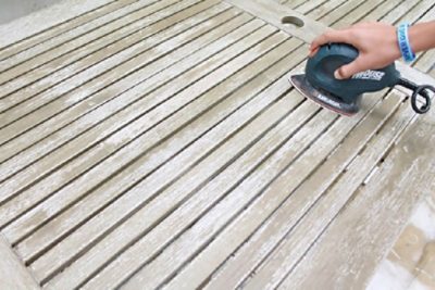 Preparing and sanding an exterior table.
