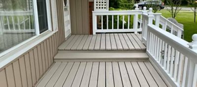 A freshly painted front porch with white trim.