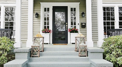 The front of a house with a gray brick porch