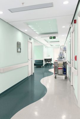 A hospital hallway with walls painted Slow Green SW6456.