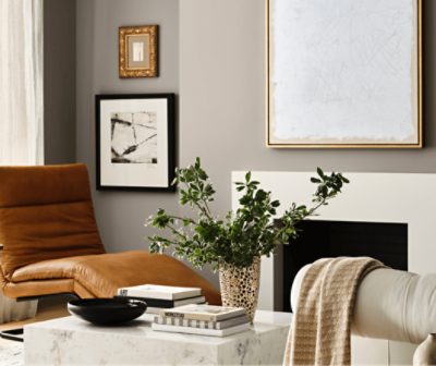 A neutral sitting room with a fireplace painted in Pavestone SW 7642.
