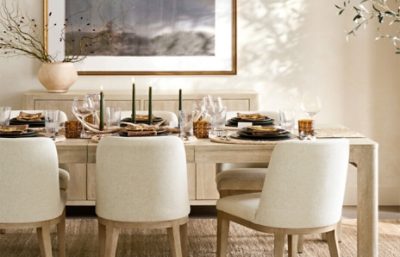 Dining room walls painted in Alabaster SW 7008 with a rectangular table set with plates, glassware, silverware and neutral chairs.