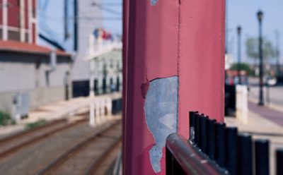 An outdoor pole with peeling metal.