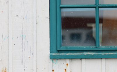 An exterior window sill with chipped paint. 