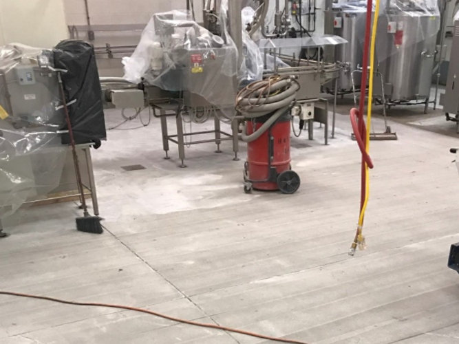 Floor cracking being repaired at a food and beverage facility