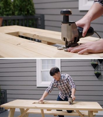 A person cutting out a hole in a picnic table with a hand saw.