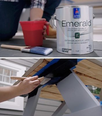 A can of Emerald Exterior Acrylic Latex paint and a person painting the underside of a picnic table.