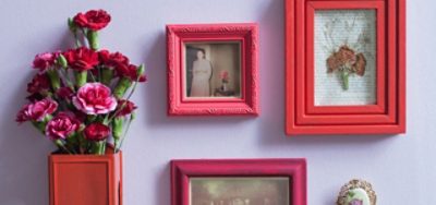 Pink and red frames with flowers on a wall