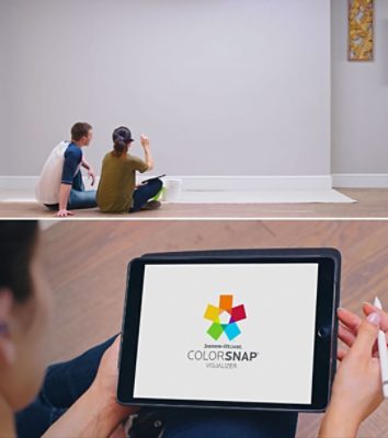 A man and woman planning how to paint a wall.