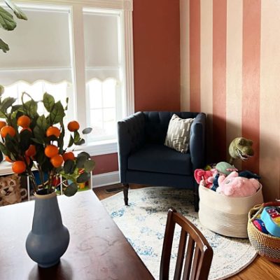 A kids' playroom wall with red and pink stripes. S-W featured colors: SW 9006 Rojo Dust, SW 0079 Pinky Beige.