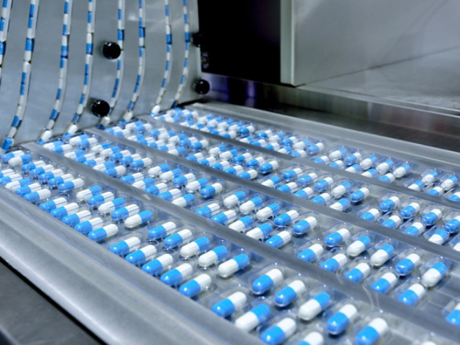 Pills being manufactured on an assembly line