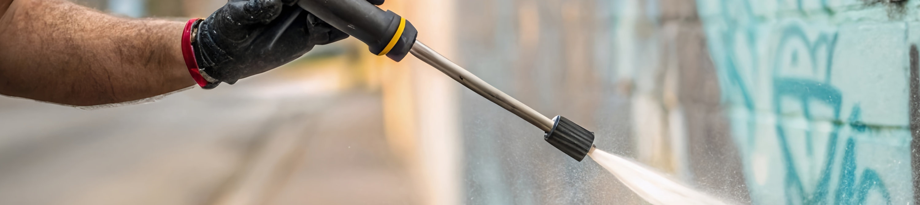 Concrete structures with graffiti being power washed