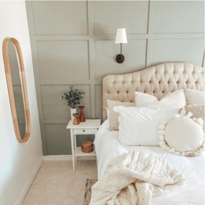 A primary bedroom with Sherwin-Williams 2022 color of the year, Evergreen Fog, painted accent wall.