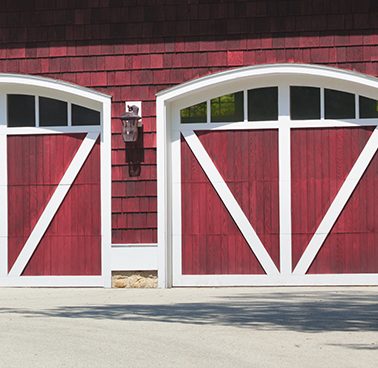 A set of two red farmhouse style garage doors.