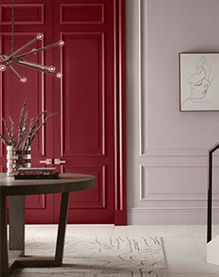 Red double doors, light purple wall with print, center table near stairway,.
