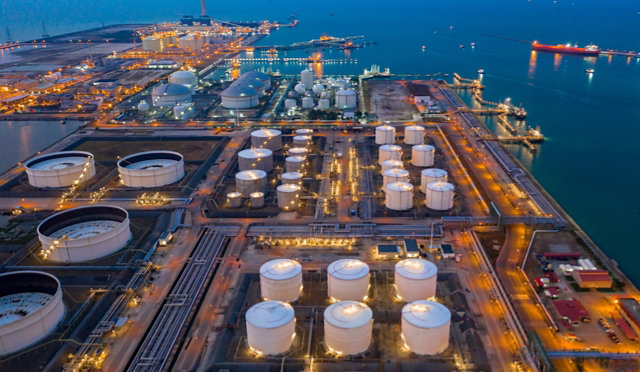 Aerial view of storage tanks at a refinery at night