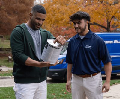 A Sherwin-Williams delivery driver dropping off a gallon of paint to a customer.
