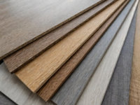Selection of wood flooring panels in different finishes and colours, showcasing design versatility and surface treatments.