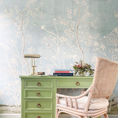 A office with rustic plant patterned wallpaper.