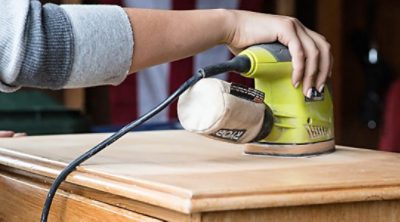 Sanding a wooden surface to be painted 