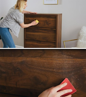 A woman sanding a dresser