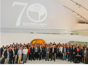 Group photo celebrating Sayerlack's 70th anniversary, highlighting decades of innovation in wood coatings.