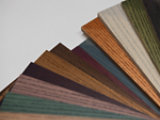 Cromalia Trends wood dyes displayed on a fan-shaped set of wood samples, highlighting a spectrum of natural and contemporary color finishes with visible wood grain.