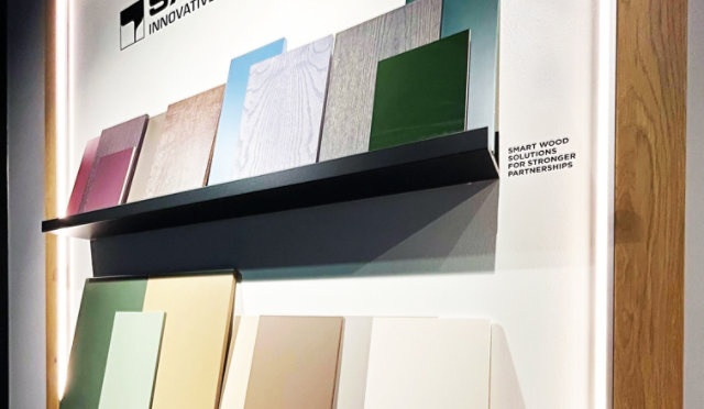 Sayerlack display featuring wood coating samples in various colors and finishes 