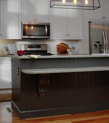 A kitchen white with painted cabinets and hardwood floors