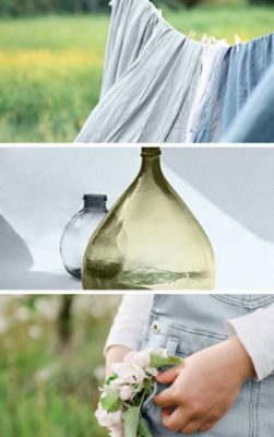 Frist image: Light blue linen fabric blowing in the breeze on an outdoor clothesline. Second image: Transparent glass vessels, one blue and one dark green, on a white surface and background in sunlight. Third image: Close crop of girl standing outside in light blue overalls with a small bunch of pink flowers in the hip pocket.