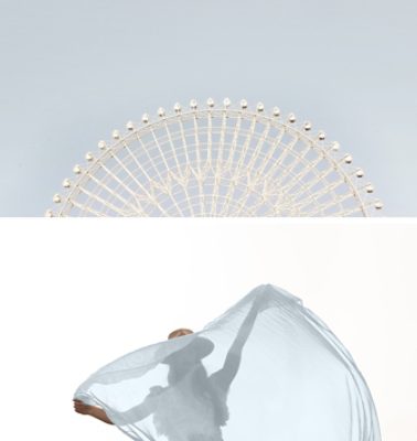 First image: Large Ferris wheel against a pale blue-gray sky. Second image: Woman in a hat silhouetted in front of a bright daytime sky and obscured behind a sheer light blue-gray fabric.