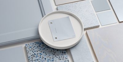 Flat lay of Upward paint chip centered with other Sherwin-Williams coatings samples arranged around it.