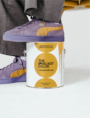 Purple and Kingdom Gold shoes with one foot resting on a can of paint labeled The Loneliest Color by Sherwin-Williams.